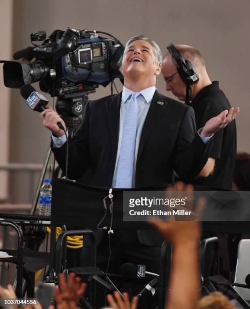 Fox News Channel and radio talk show host Sean Hannity reacts to attendees before a Donald Trump campaign rally at the Las Vegas Convention Center on...