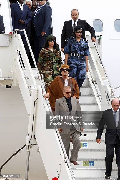 Libyan leader Muammar Gaddafi, escorted by female bodyguards, arrives at the Ciampino airport on August 29, 2010 in Rome, Italy. Gadaffi is on an...