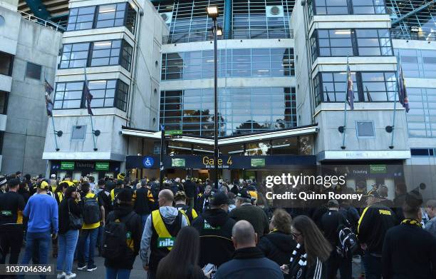 Fans queue outsdie the MCG on September 21, 2018 in Melbourne, Australia. Over 100,000 fans are expected in Melbourne's sporting precinct as the city...