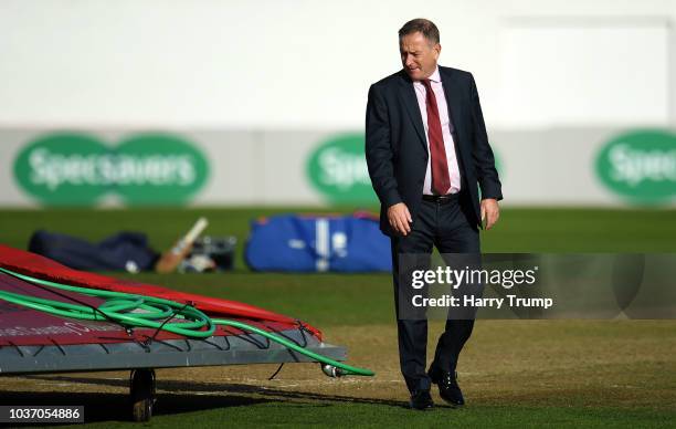 Andrew Cornish, CEO of Somerset inspects the pitch as strong winds and heavy rain force a section of the covers to blow off and damage the pitch...