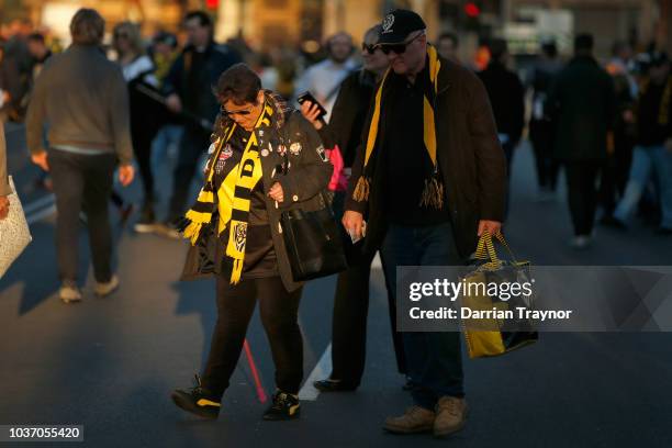 Richmond fans walk to the M.C.G. On September 21, 2018 in Melbourne, Australia. Over 100,000 fans are expected in Melbourne's sporting precinct as...