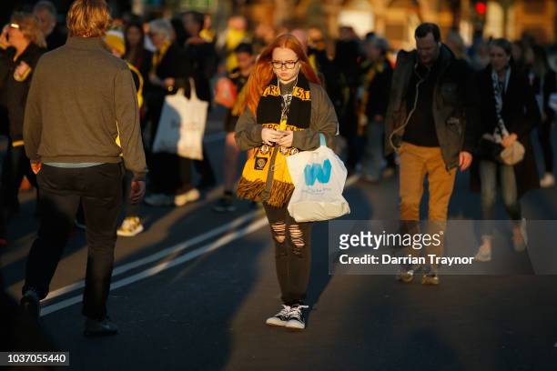 Richmond fans walk to the M.C.G. On September 21, 2018 in Melbourne, Australia. Over 100,000 fans are expected in Melbourne's sporting precinct as...