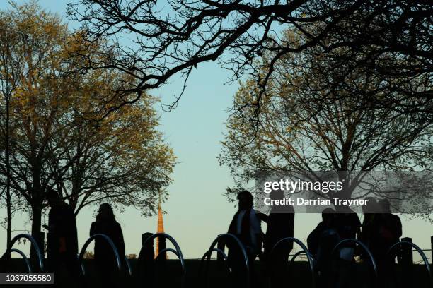 Football fans walk to the M.C.G. On September 21, 2018 in Melbourne, Australia. Over 100,000 fans are expected in Melbourne's sporting precinct as...