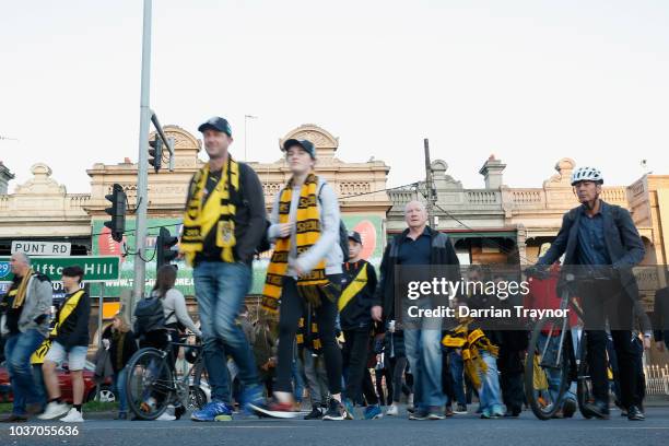 Football fans walk to the M.C.G. On September 21, 2018 in Melbourne, Australia. Over 100,000 fans are expected in Melbourne's sporting precinct as...