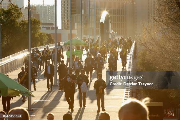 Football fans walk to the M.C.G. On September 21, 2018 in Melbourne, Australia. Over 100,000 fans are expected in Melbourne's sporting precinct as...
