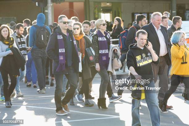 And NRL Football fans walk through the city on September 21, 2018 in Melbourne, Australia. Over 100,000 fans are expected in Melbourne's sporting...