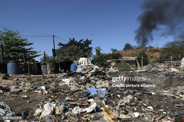 Dumps of garbage can be seen to crude dwellings in the slums of Gramacho in Rio de Janeiro, Brazil, 13 August 2016. Here hundreds of people live in...