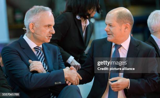 Johannes Teyssen shakes hands with Hamburg's First Mayor Olaf Scholz at the official inaugural cermony of the 'Amrumbank West' offshore wind park, in...