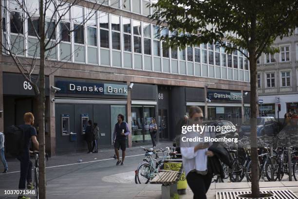 Customers use an automated teller machine outside a Danske Bank A/S bank branch in central Copenhagen, Denmark, on Wednesday, Sept. 19, 2018. Danske...