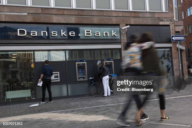 Customers use automated teller machines outside a Danske Bank A/S bank branch in Copenhagen, Denmark, on Wednesday, Sept. 19, 2018. Danske Bank...