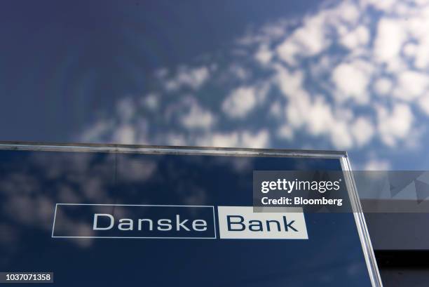 Logo sits on display in the window of a Danske Bank A/S bank branch in Copenhagen, Denmark, on Wednesday, Sept. 19, 2018. Danske Bank A/S Chief...