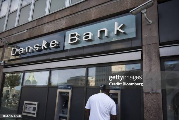 Customer uses an automated teller machine outside a Danske Bank A/S bank branch in Copenhagen, Denmark, on Wednesday, Sept. 19, 2018. Danske Bank...