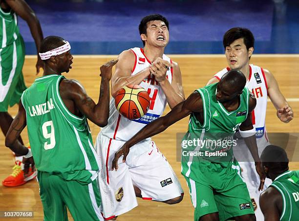 Mamadou Lamizana and Kinidinnin Konate of Cote d'Ivoire battles for the ball with Jinhui Ding of China at the 2010 World Championships of Basketball...