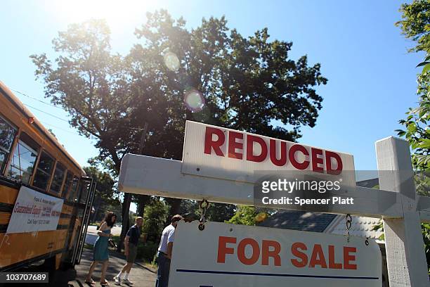 Prospective home buyers exit a bus at a foreclosed home on August 29, 2010 in Seymour, Connecticut. The home was one of numerous foreclosed homes on...