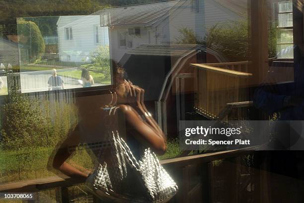 Prospective home buyer Michelle Lathrop is reflected in a window of a foreclosed home on August 29, 2010 in Seymour, Connecticut. The home was one of...