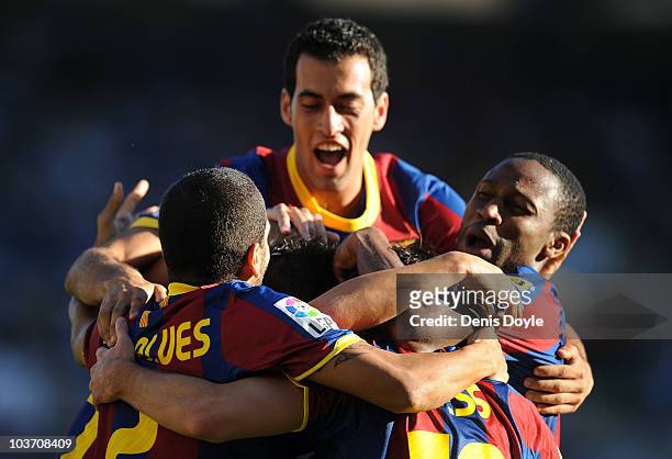 Leo Messi of Barcelona celebrates with Seydou Keita and Dani Alves after scoring Barcelona's first goal during the La Liga match between Racing...