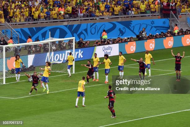 Germany's Thomas Mueller celebrates after scoring the 0-1 goal during the FIFA World Cup 2014 semi-final soccer match between Brazil and Germany at...