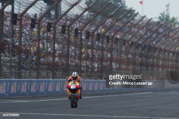Dani Pedrosa of Spain and Repsol Honda Team cuts the finish lane and celebrates the victory at the end of MotoGP race of the Red Bull Indianapolis...