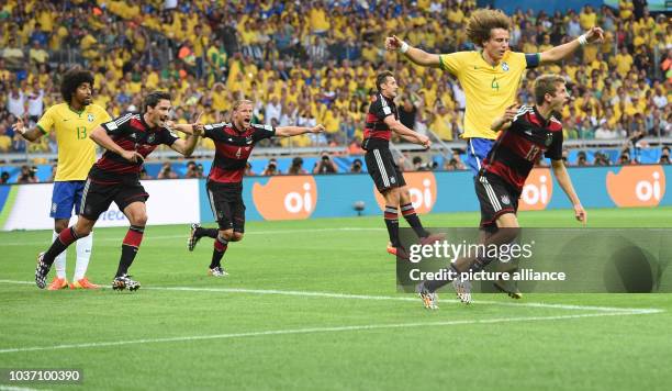 Germany's Thomas Mueller celebrates after scoring the 0-1 during the FIFA World Cup 2014 semi-final soccer match between Brazil and Germany at...