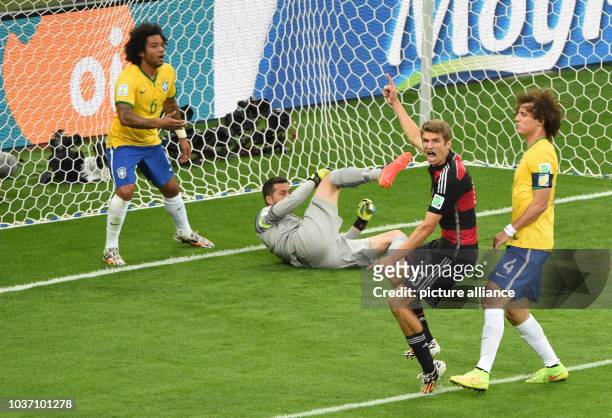Germany's Thomas Mueller gestures after scoring the 0-1 during the FIFA World Cup 2014 semi-final soccer match between Brazil and Germany at Estadio...