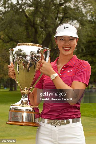 Michelle Wie of the U.S. Poses with the champion's trophy following her victory at the CN Canadian Women's Open at St. Charles Country Club on August...