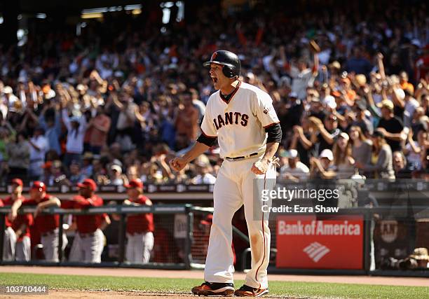 Freddy Sanchez of the San Francisco Giants celebrates after he scored on a single by Jose Guillen to tie their game 6-6 in the seventh inning of...
