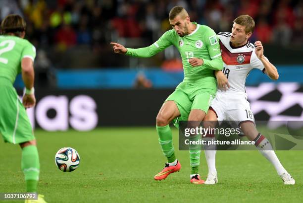 Germany's Toni Kroos and Islam Slimani of Algeria vie for the ball during the FIFA World Cup 2014 round of 16 soccer match between Germany and...