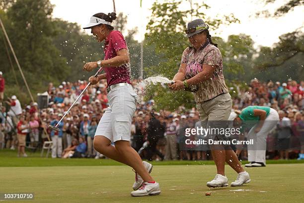 Christina Kim of the U.S. Douses Michelle Wie of the U.S. With champagne following Wie's victory at the CN Canadian Women's Open at St. Charles...