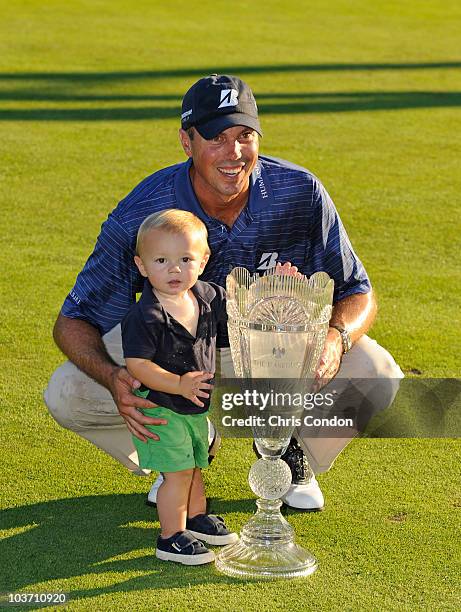 Matt Kuchar poses with son Carson and the tournament trophy after winning The Barclays at Ridgewood Country Club on August 29, 2010 in Paramus, New...