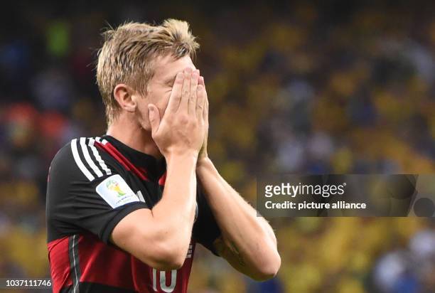 Germany's Toni Kroos reacts during the FIFA World Cup 2014 semi-final match between Brazil and Germany at the Estadio Mineirao in Belo Horizonte,...