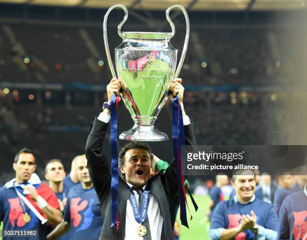 Barcelona's head coach Luis Enrique celebrates with the trophy after the UEFA Champions League final soccer match between Juventus FC and FC...