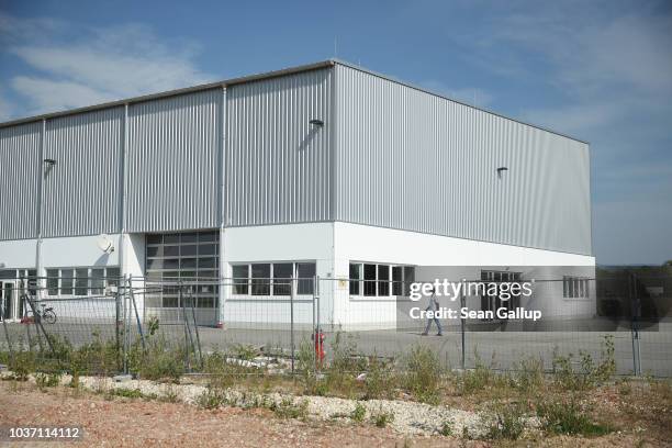 One of Bavaria's newly-introduced "anchor centers" for asylum applicants at a former warehouse stands in an industrial park near Stephansposching on...