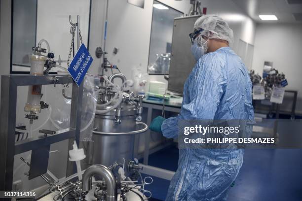 Technician works on a production line on September 21 at Sanofi Genzyme site in Lyon, southeastern France. - Sanofi Genzyme biotechnology company...