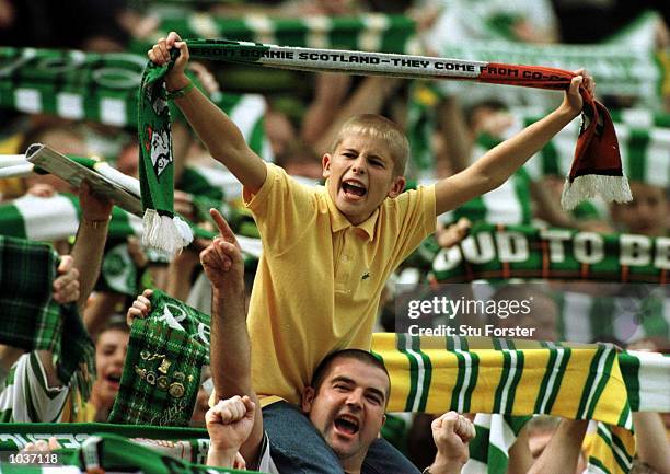 Young celtic fan cheers his team during the Glasgow Celtic v Glasgow Rangers Bank of Scotland Premier League match at Celtic Park, Glasgow. Mandatory...