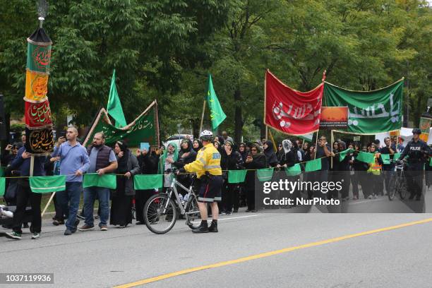 Shiite Muslim mourners take part in a Muharram procession in Toronto, Ontario, Canada, on September 20, 2018. Hundreds of Shiite Muslims took to the...