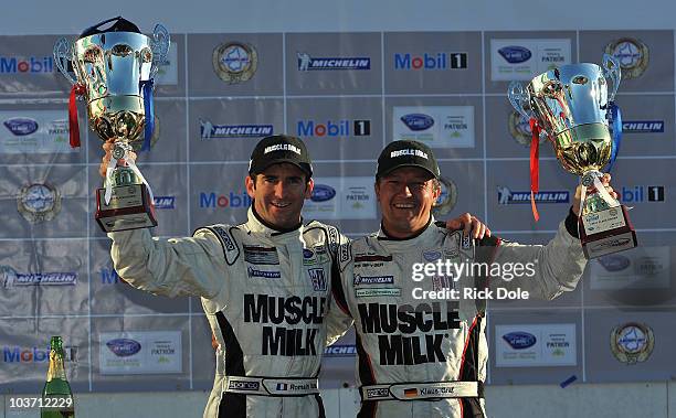 Romain Dumas of France and Klaus Graf of Germany, drivers of the Muscle Milk Team Cytosport Porsche RS Spyder, celebrate their victory at the...