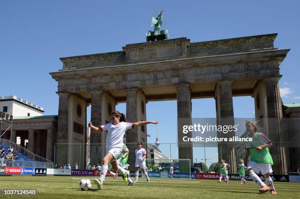 Girls play on an artificial field at the Fan Festival for the UEFA Champions League Finale in front of the Brandenburg Gate in Berlin, Germany, 04...