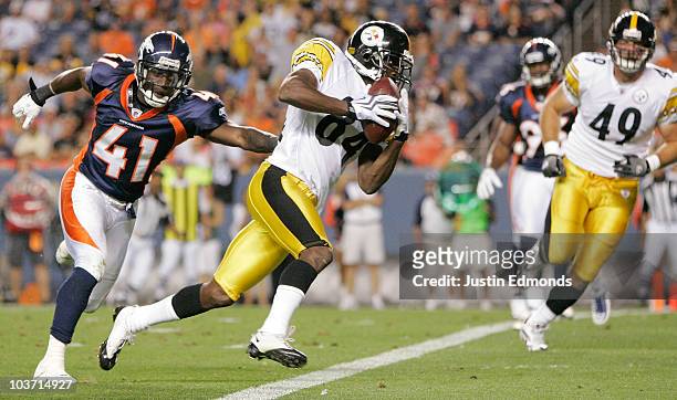 Wide receiver Antonio Brown of the Pittsburgh Steelers beats cornerback Cassius Vaughn of the Denver Broncos and scores a touchdown at INVESCO Field...