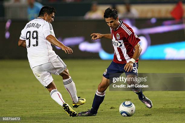 Marcelo Saragosa of Chivas USA strips the ball from Jaime Moreno of D.C. United during the MLS match on August 29, 2010 at the Home Depot Center in...