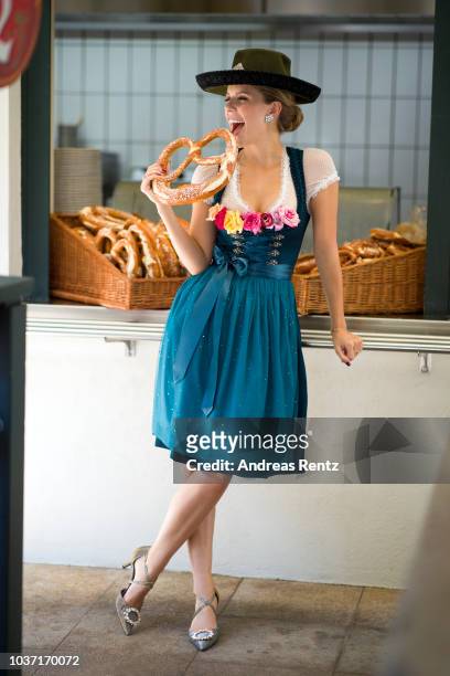 Victoria Swarovski, wearing a dirndl from her collection with Krueger, poses at the Wirtshaus am Bavariapark on September 18, 2018 in Munich, Germany.