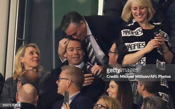 Eddie McGuire kisses Gillon McLachlan, Chief Executive Officer of the AFL during the 2018 AFL First Preliminary Final match between the Richmond...