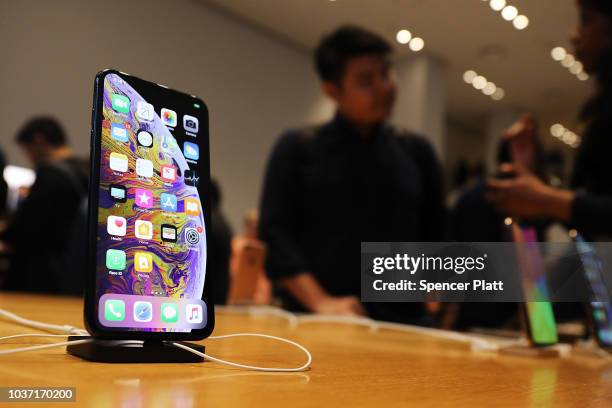 People purchase the new iPhone XS and XS Max at the Apple store in Midtown Manhattan on September 21, 2018 in New York City. The two new phones,...