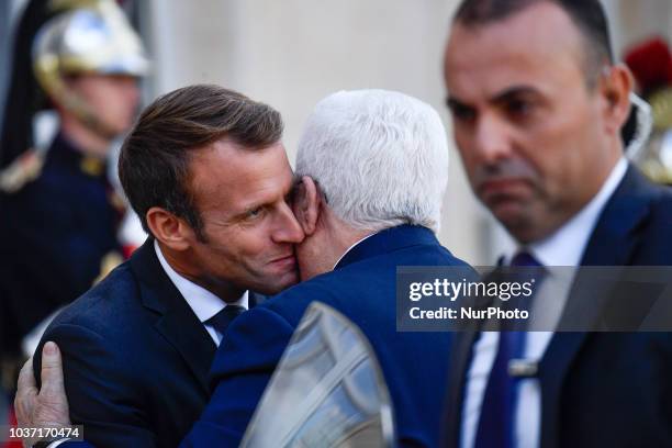 French President Emmanuel Macron welcomes Palestinian president Mahmud Abbas prior to their meeting at the Elysee Palace, on September 21, 2018 in...