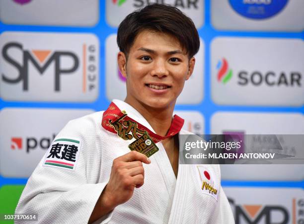 Japan's Hifumi Abe poses with his gold medal in the under 66kg men category of the 2018 Judo World Championships in Baku on September 21, 2018.