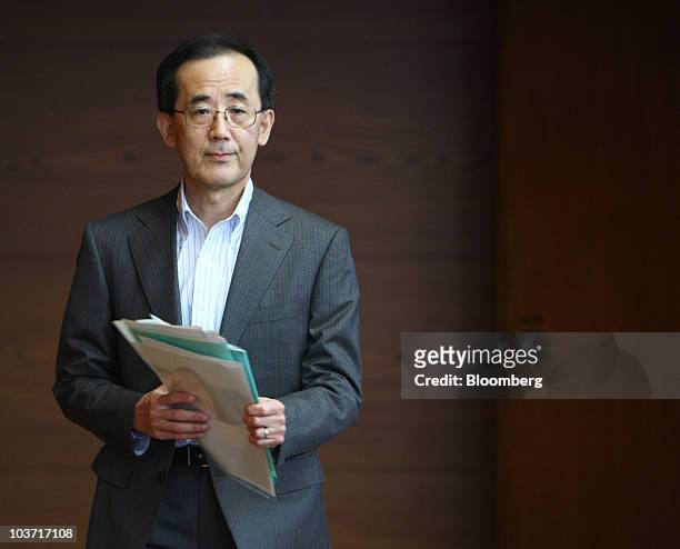 Masaaki Shirakawa, governor of the Bank of Japan, arrives for a news conference after an emergency board meeting at the central bank's headquarters...