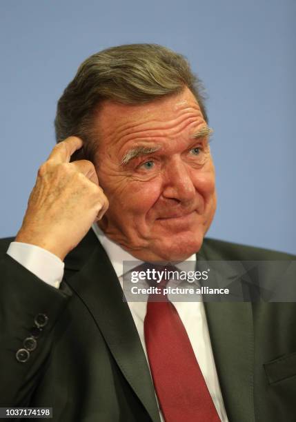 Former German Chancellor Gerhard Schroeder attends a presentation of his new biography with his successor, current chancellor Angela Merkel , in...