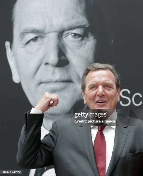 Former German Chancellor Gerhard Schroeder speaks during a presentation of his new biography with his successor, current chancellor Angela Merkel ,...