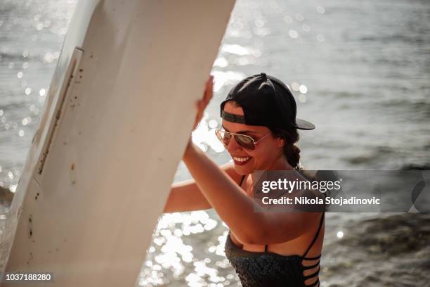 woman posing with paddleboard - woman bungee jumping stock pictures, royalty-free photos & images