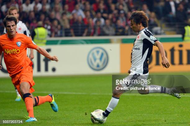 Frankfurt's Takashi Inui scores the 1-0 goal against Bochum's Jonas Acquistapace during the DFB-Cup match between Eintracht Frankfurt and VfL Bochum...