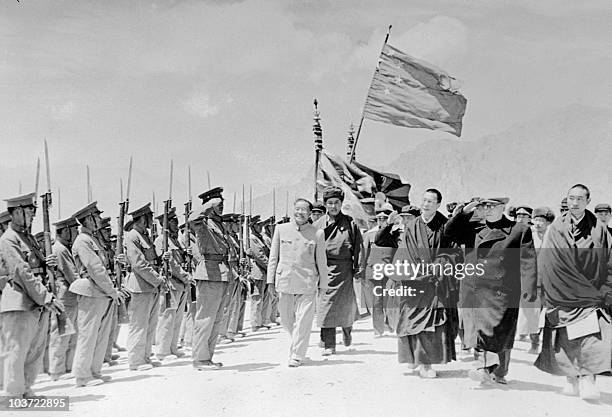 Panchen Lama, Chinese vice-premier Chen Yi, and the Dalai Lama, review a Tibetan guard of honour wearing Chinese army uniforms in May 1956 in Lhasa,...